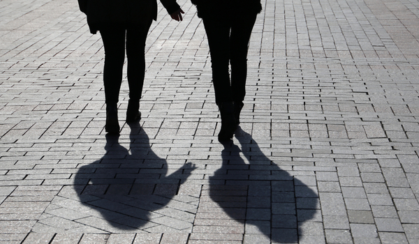 Silhouette Shadow of two women walking on the street