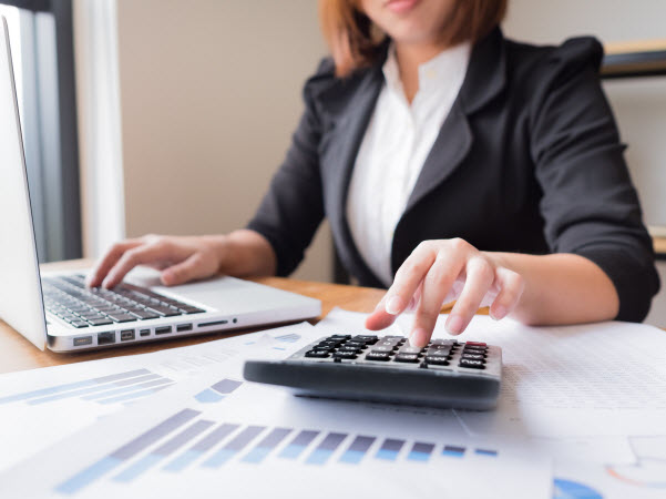 Female accountant computing financial graph