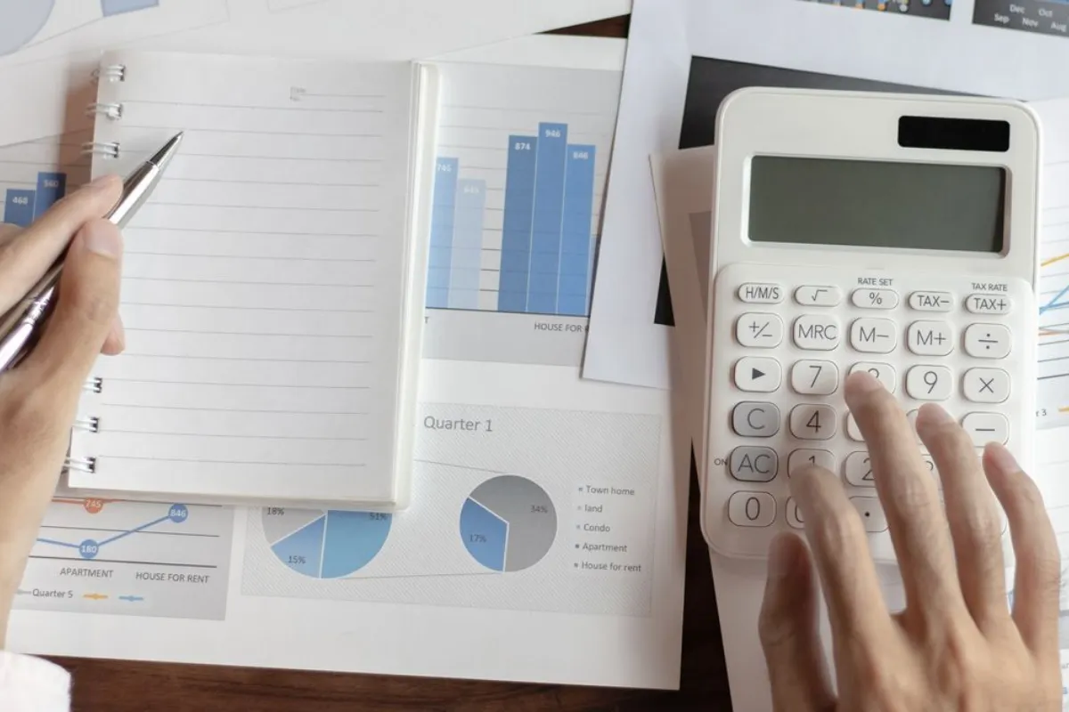AFG - Paying what it takes Notebook with a calculator on the table